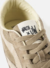 Extreme close-up detail shot of the Walsh x Universal Works Cob in Camel Leather upper on a light background, emphasizing the premium grain texture, eyelets, and tonal laces of the collaborative shoe.
