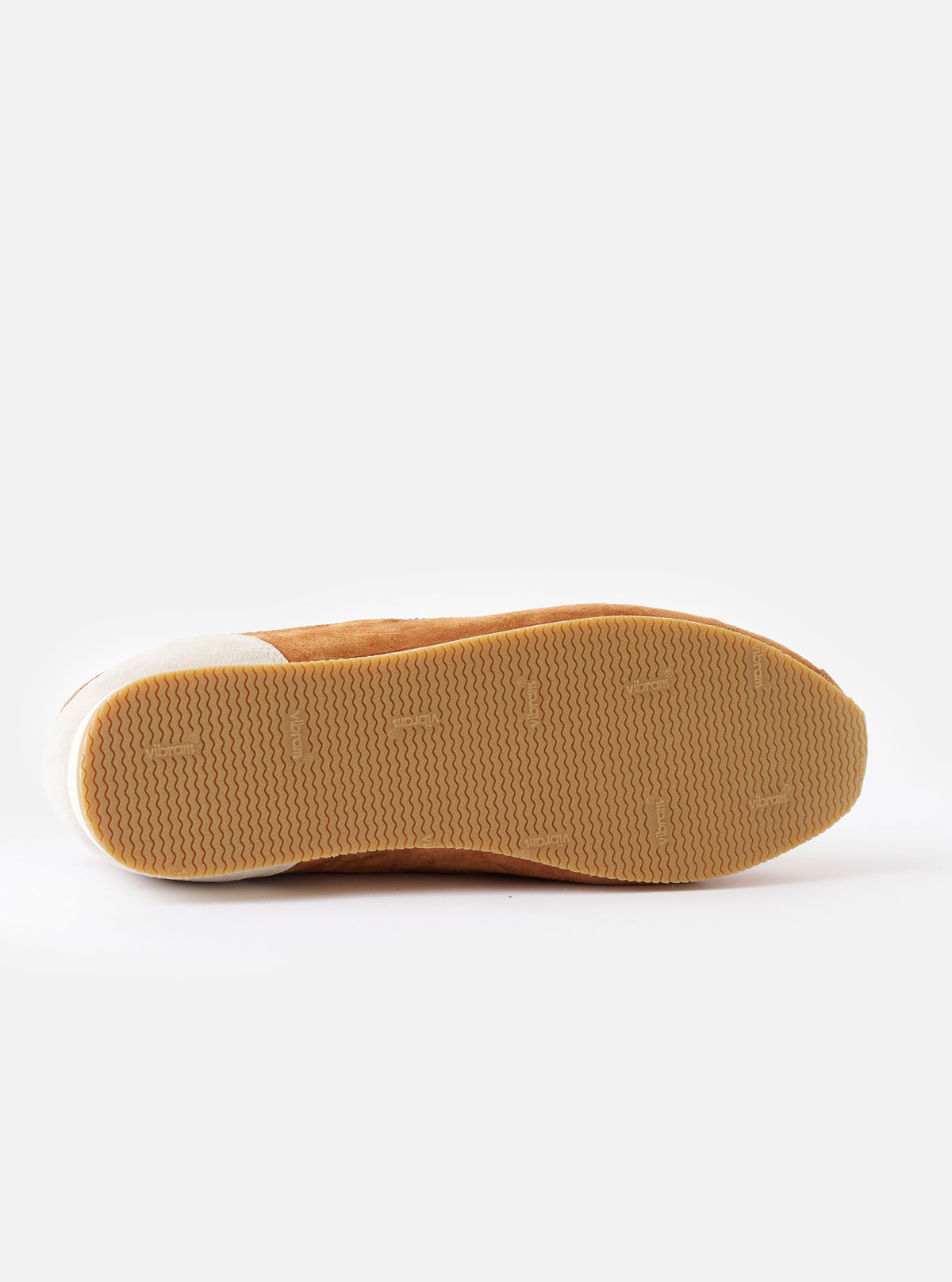 Overhead top-down image of the Walsh x Universal Works Cob in Tan Leather on a neutral studio background, showcasing the opening rim, inner lining details, and sleek toe box shape of the footwear.