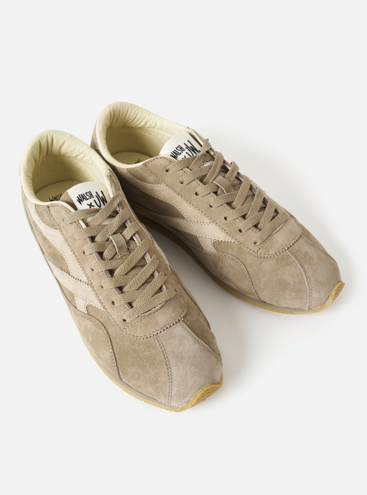 Rear view of the Walsh x Universal Works Cob in Camel Leather against a neutral backdrop, highlighting the sculpted heel counter, sturdy back pull tab detail, and layered rubber sole construction.