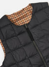 Close-up of the TAION x Universal Works Reversible Black Military Line Vest on a white background. The vest is black with a quilted pattern and a visible brown houndstooth pattern on the reverse side.