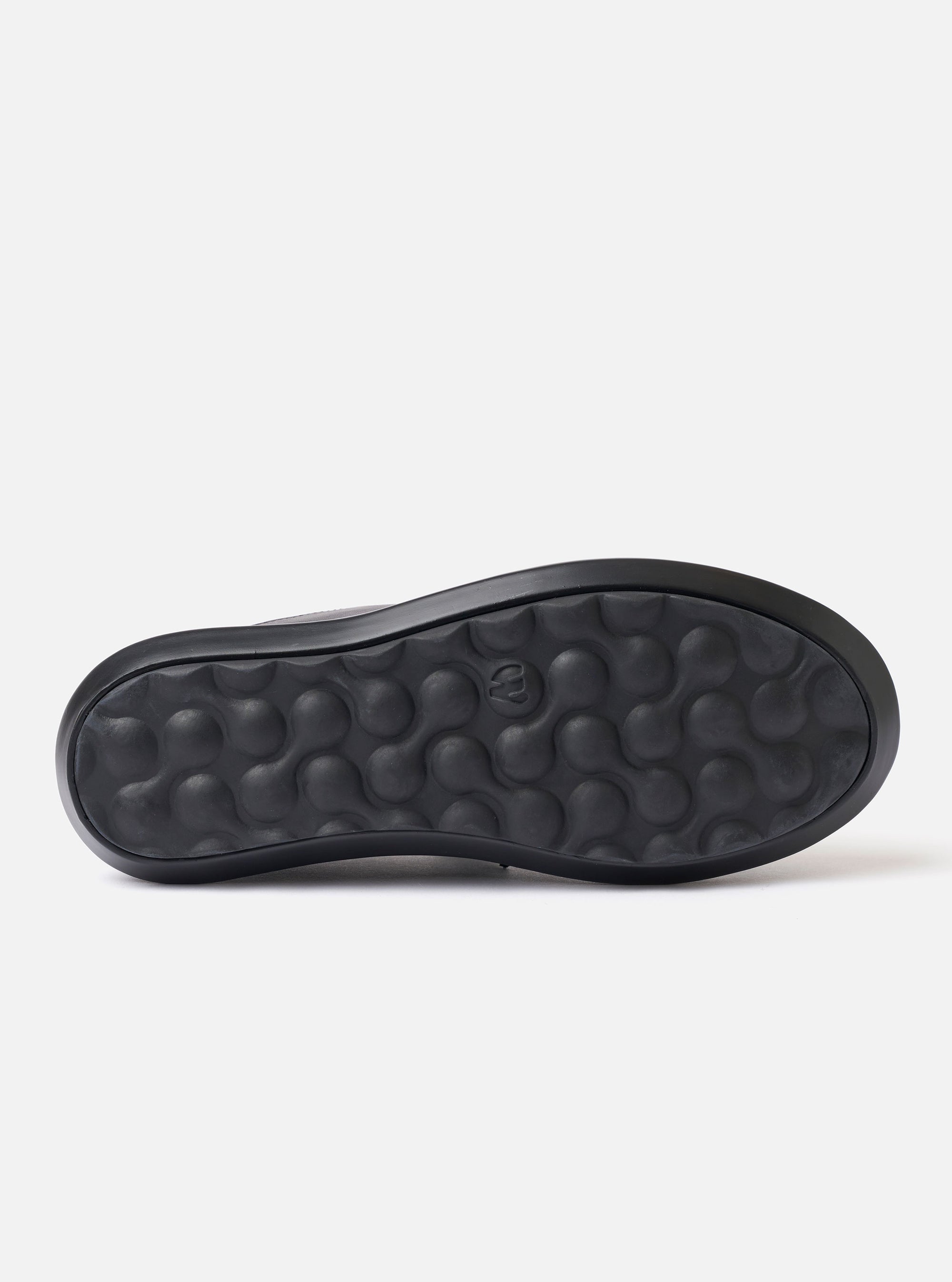 The Wander etc. Laze in Black Nappa Leather is shown as a flat lay against a plain white background. The footwear is a backless mule style featuring a smooth black nappa leather upper and a chunky black phylon and gum outsole. The interior reveals a cork footbed with a printed logo.