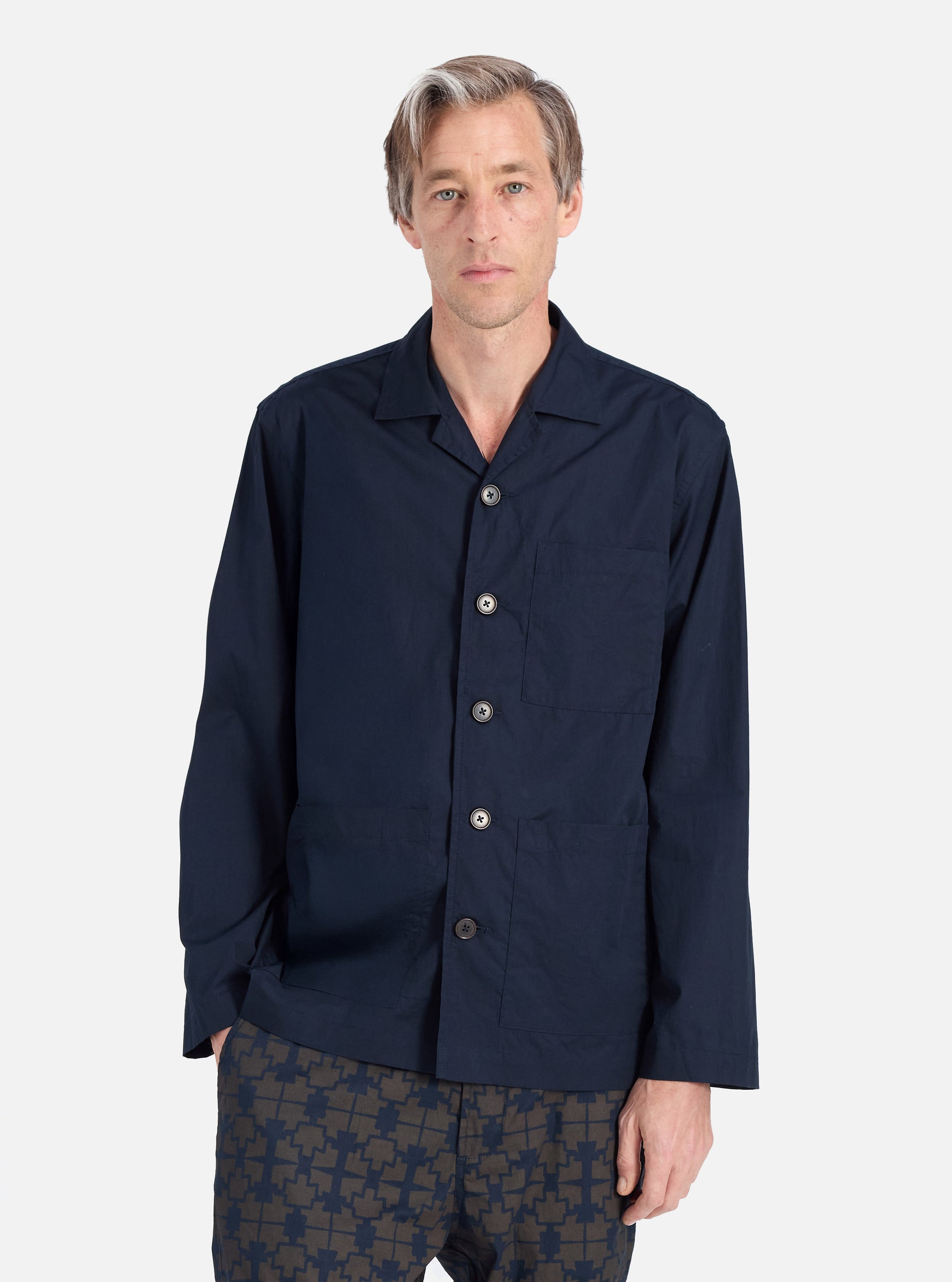 A model wears a Navy Broadcloth Cancun Jacket in navy broadcloth on a white background. The jacket has a relaxed fit and button closure.