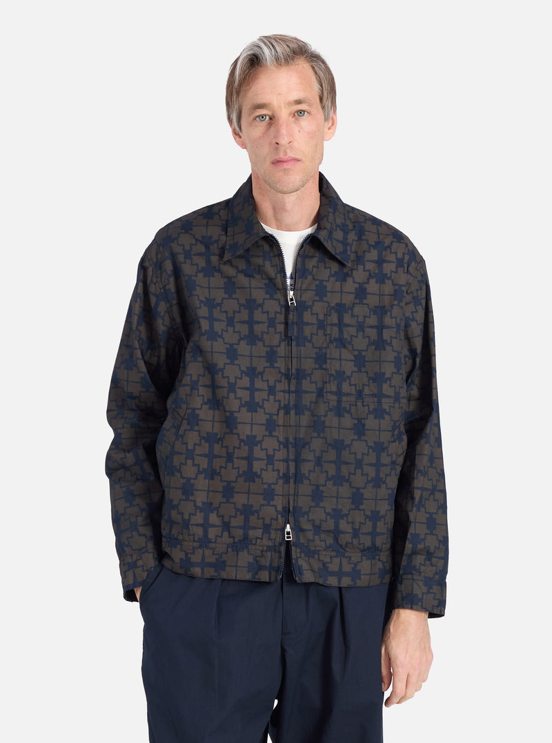 A man models the Navy Mitla Print Cotton Rose Bowl Jacket against a white background. The jacket features a unique print and a comfortable fit.