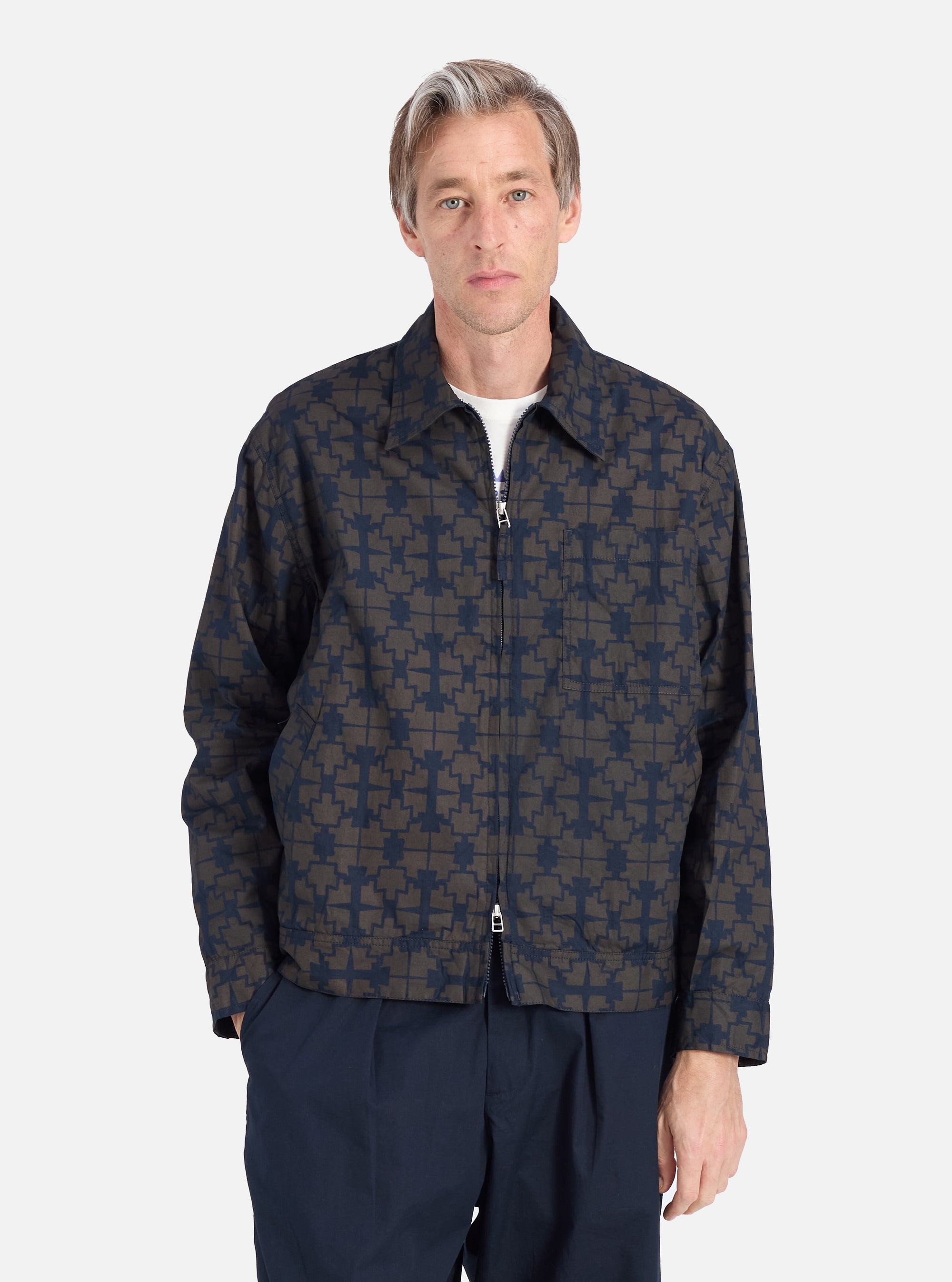 A man models the Navy Mitla Print Cotton Rose Bowl Jacket against a white background. The jacket features a unique print and a comfortable fit.