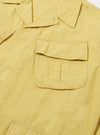 Close-up of the Lemon Linen Slub Weave Jungle Jacket on a white background. The lemon-colored linen jacket features chest pockets and a relaxed fit.