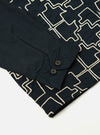 Close-up of the Navy Mitla Broadcloth Club Jacket on a white surface. The jacket is navy with a white geometric pattern and has a buttoned cuff.