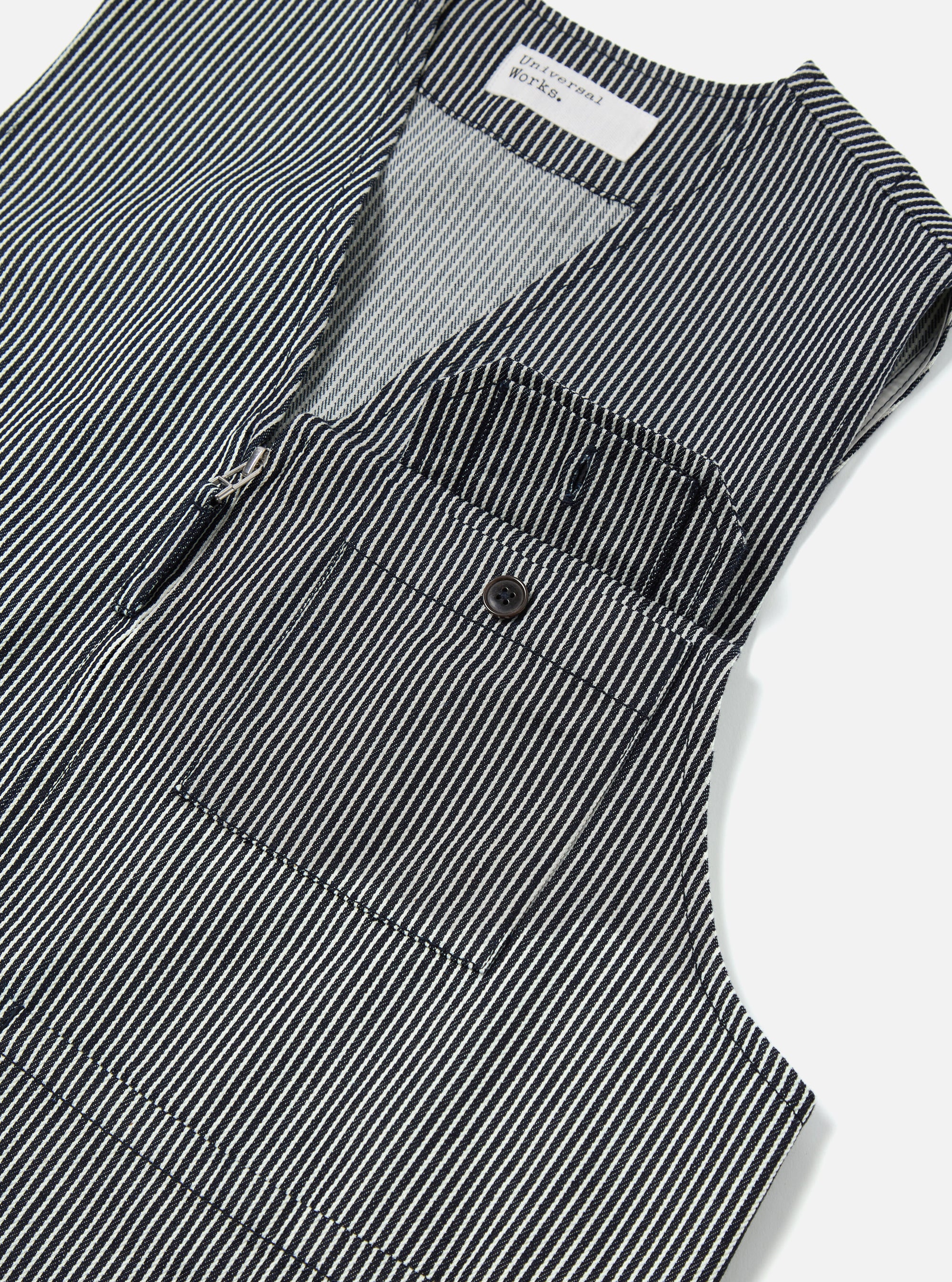 Close-up of the Indigo Hickory Stripe Denim Marine Gilet, showcasing the blue and white striped denim material, front zip, and pocket detail. Shot on a clean, bright background.