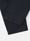 Close-up of the Navy Linen Slub Weave Oxford Pant on a white background, showcasing the fabric's texture and the pant's hem.
