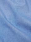 Close-up of the Blue End On End Cotton Utility SS Shirt fabric. The light blue cotton material has a subtle texture. The shirt is neatly folded on a flat surface.