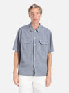 A model wears the Grey End On End Cotton Utility SS Shirt. The shirt is grey with white stitching on the pockets and collar. The background is a clean, bright white.