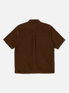 Back view of the Khaki Summer Cord Tech Overshirt, a brown short-sleeve corduroy shirt on a white background. The shirt has a classic collar and a straight hem.