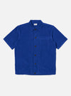 The Work Blue Summer Cord Tech Overshirt in vibrant blue corduroy. Short-sleeved, button-down on a clean white background. A stylish, lightweight overshirt.