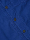 Close-up of the Work Blue Summer Cord Tech Overshirt. Shows the blue corduroy material, brown buttons, and pocket detail. Flat lay on a neutral surface.