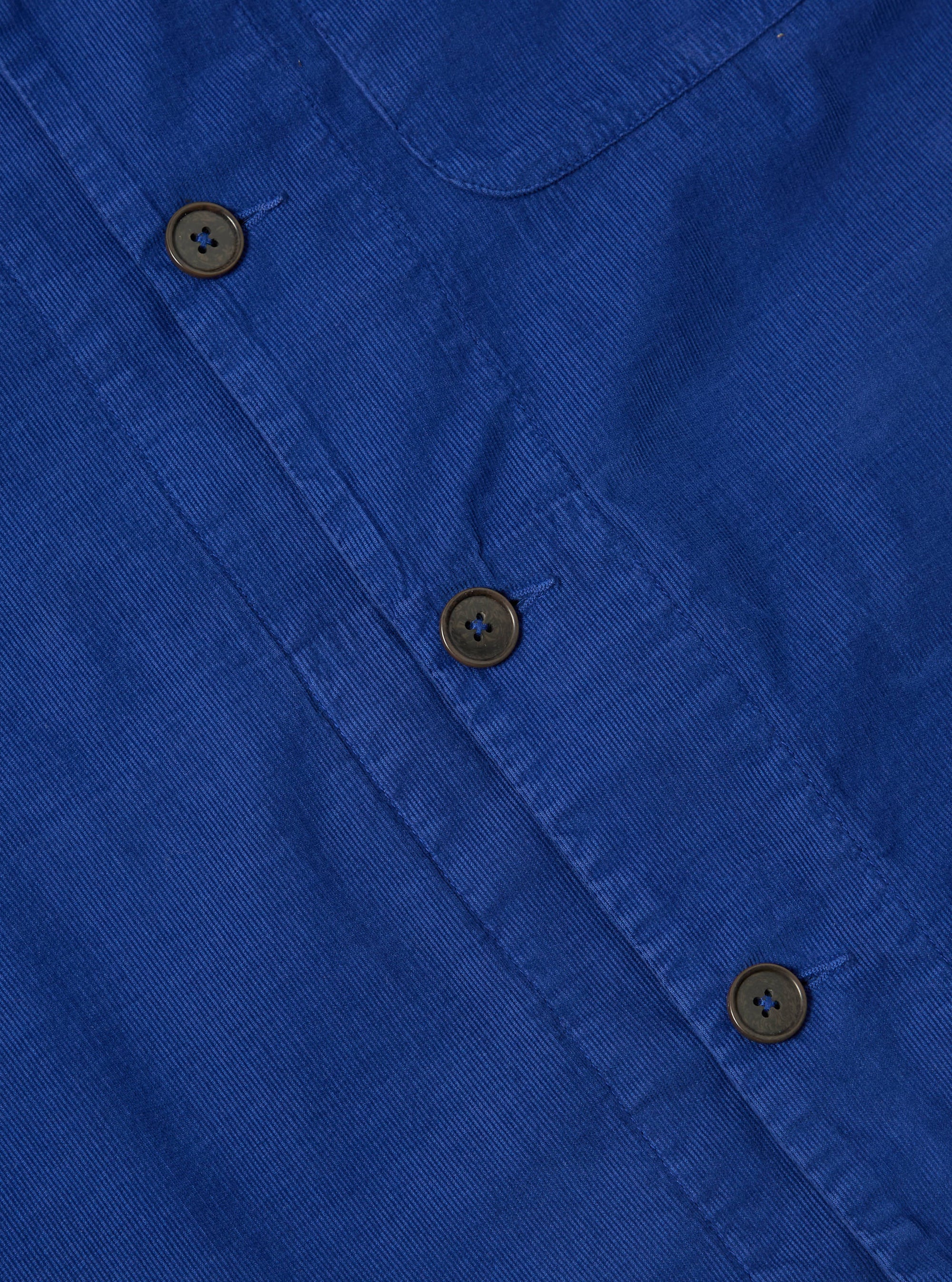 Close-up of the Work Blue Summer Cord Tech Overshirt. Shows the blue corduroy material, brown buttons, and pocket detail. Flat lay on a neutral surface.
