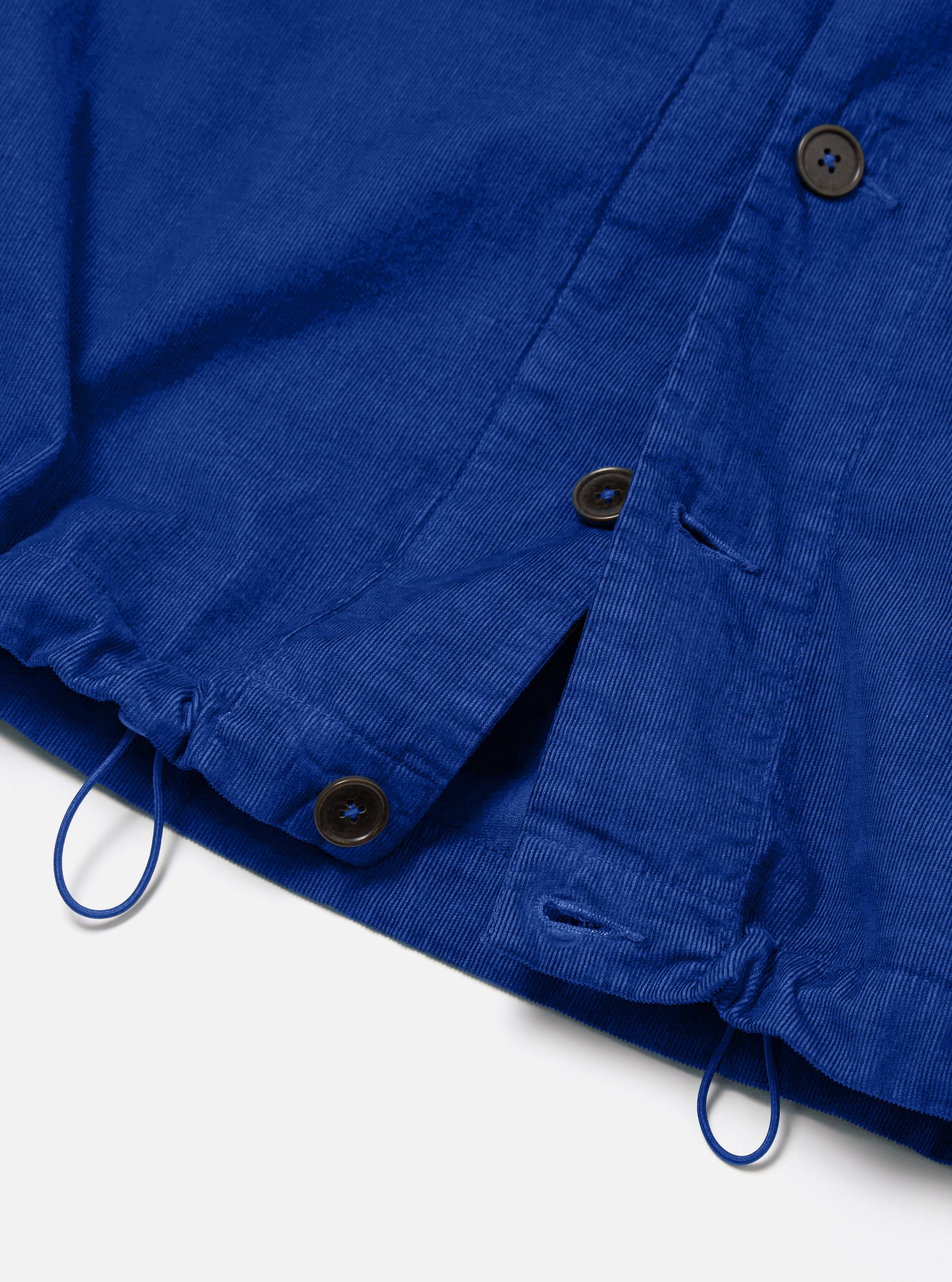 Close-up of the Work Blue Summer Cord Tech Overshirt on a white background. Shows the corduroy texture, button details, and drawstring.