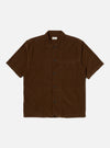 The Khaki Summer Cord Tech Overshirt in brown corduroy, laid flat on a white background. The short-sleeved shirt has a button-up front and a chest pocket.