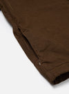 Close-up of the Khaki Summer Cord Tech Overshirt showing the corduroy texture and a side zip pocket. The overshirt is laid on a white surface.