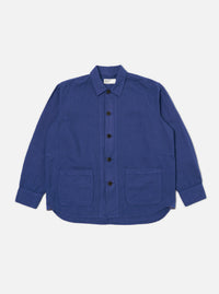 The Blue Linen Cotton Shirting Travail Overshirt is displayed on a white background. The blue overshirt features a button-down front and two front pockets.