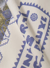 Close-up of the Ecru/Yellow Single Jersey Pickup Print Tee fabric. The ecru tee features a blue print. The fabric is folded, showcasing the soft single jersey material.