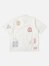 The Ecru Embroidered Poplin Minari Shirt, laid flat on a white background. The shirt features colorful embroidery details.