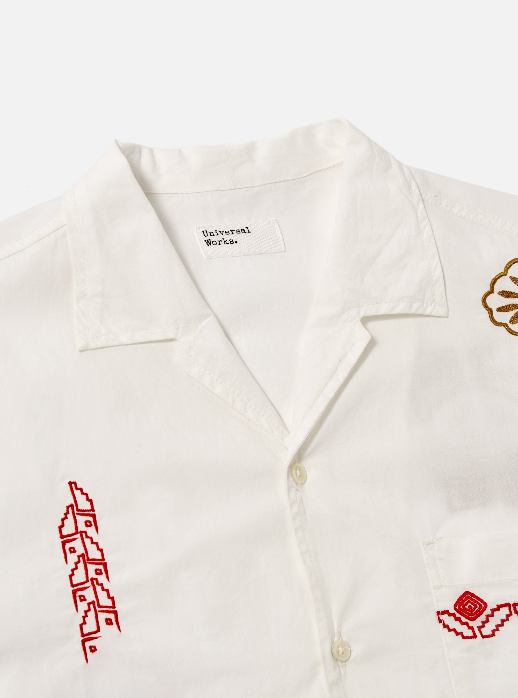 Close-up of the Ecru Embroidered Poplin Minari Shirt on a white background. The shirt features red and gold embroidery details.