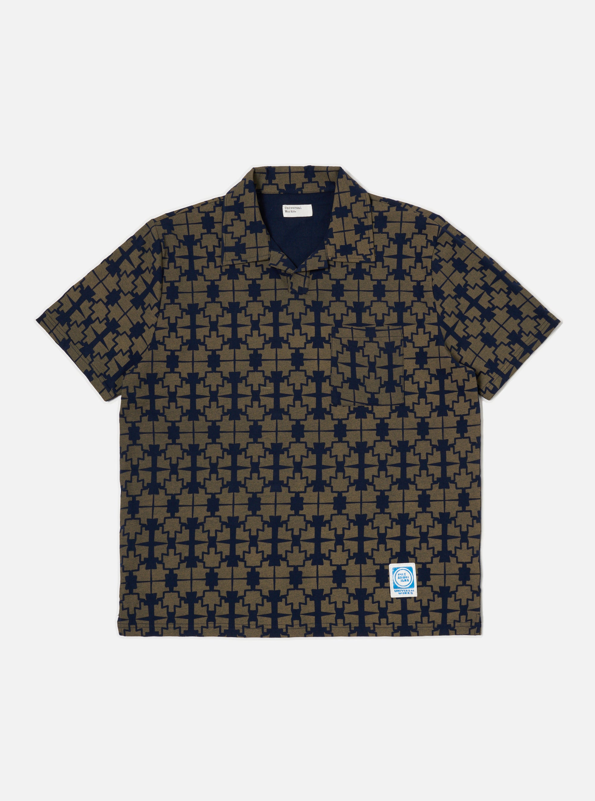 The Navy/Mud Mitla Print Jersey Newlyn Polo shirt on a white background. The polo is patterned with a navy and mud geometric print.