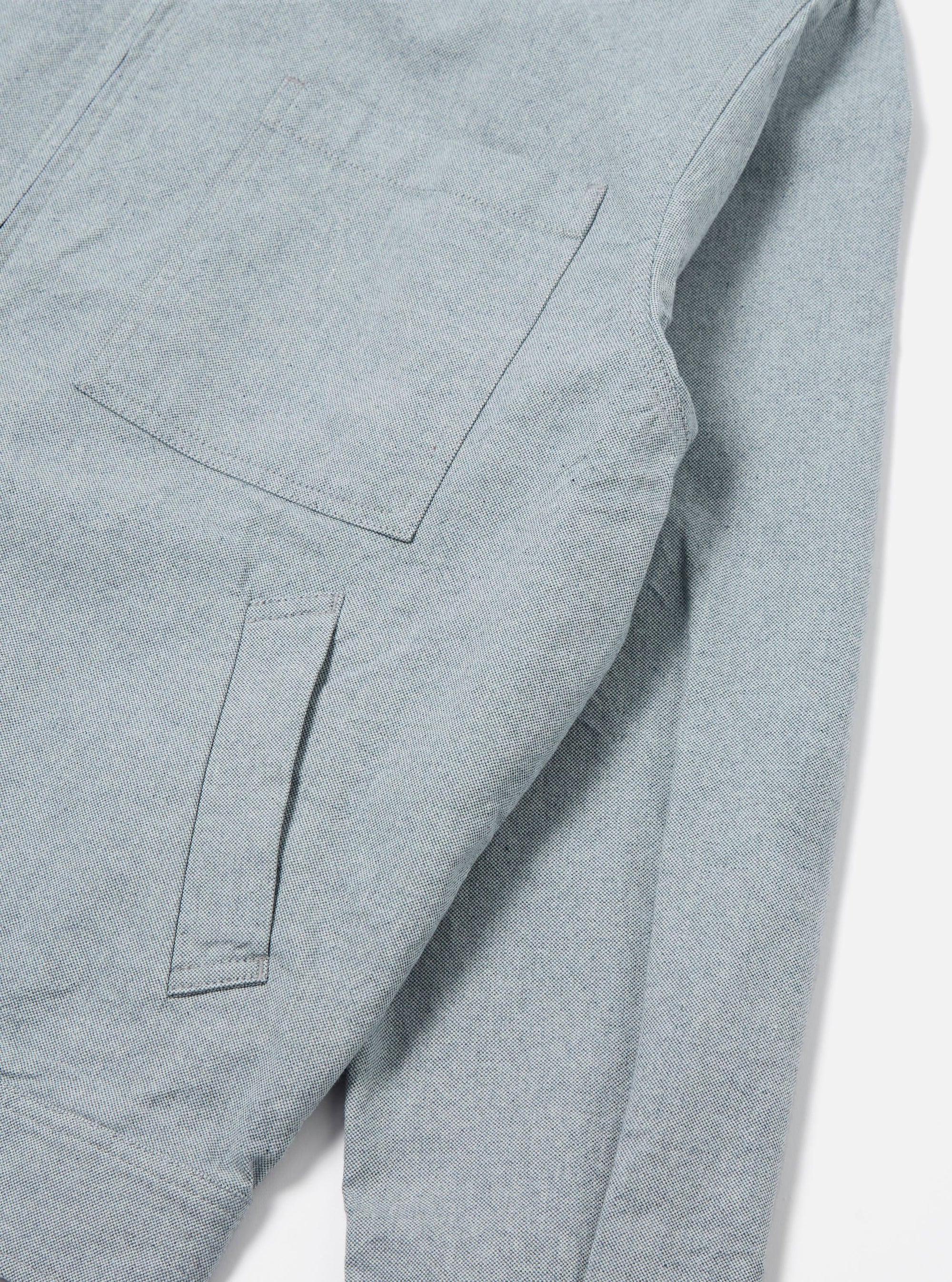 Close-up of the Indigo Reworked Jean Cloth Rose Bowl Jacket, showing the light blue denim material and pocket details. Shot on a white background.