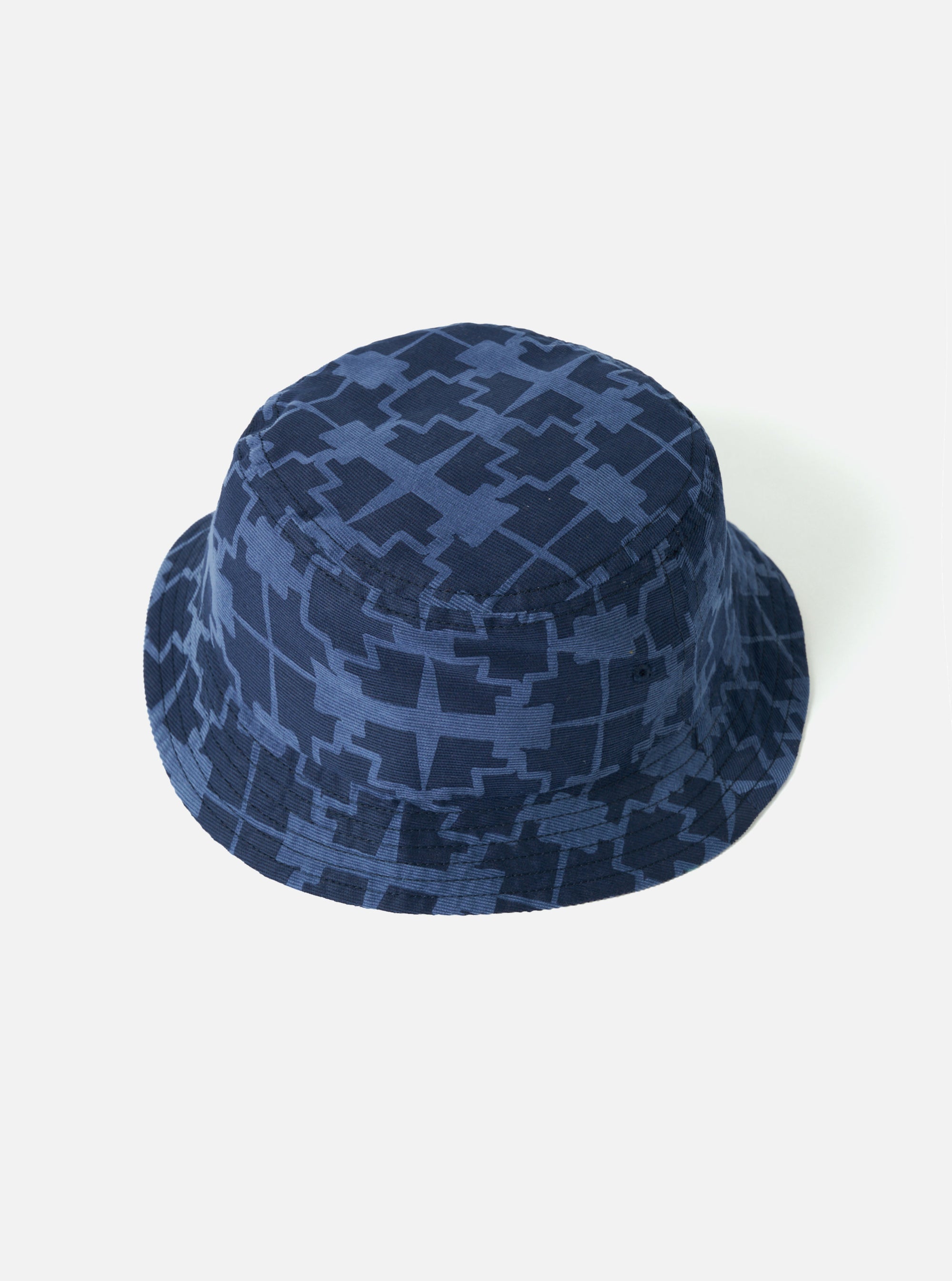 The Navy Mitla Print Cord Beach Hat on a white background. The hat is a bucket style and made of corduroy with a geometric pattern.