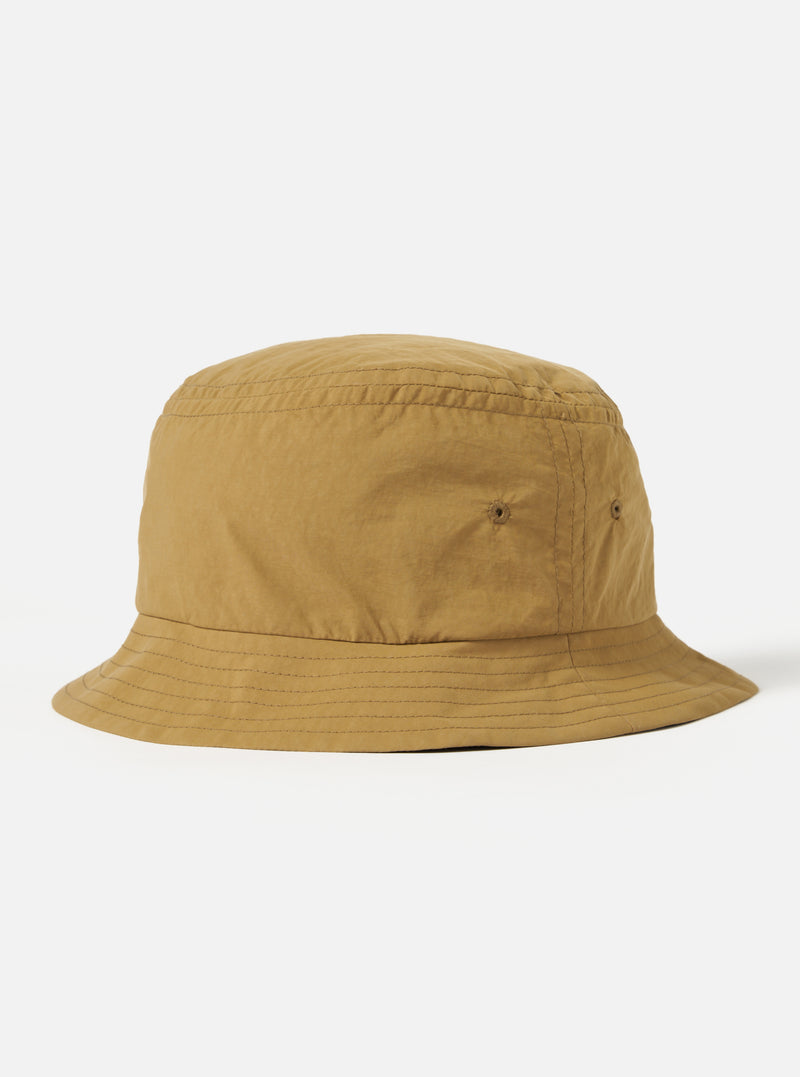 The Dark Sand Peach Recycled Nylon Beach Hat on a white background. The hat is a light brown color and made of a lightweight material.