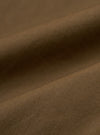 Close-up of the brown British wax cotton Boston Parka fabric. The durable material has a subtle texture. Ideal for a stylish, weather-resistant coat.
