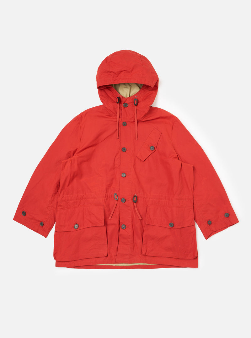 The Orange British Wax Cotton Boston Parka, laid flat on a white background. This hooded jacket features button closures and multiple pockets.
