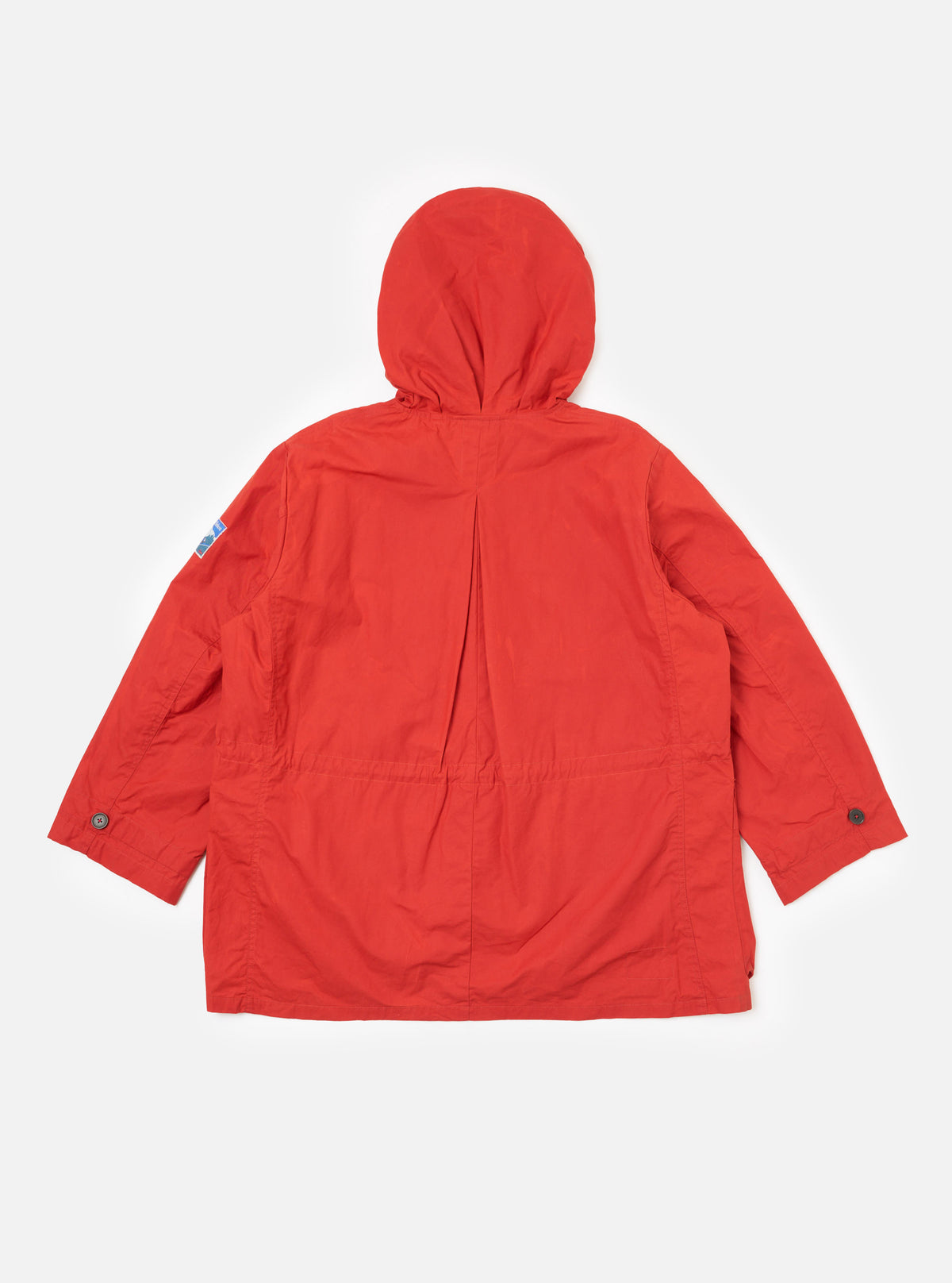 Back view of the Orange British Wax Cotton Boston Parka on a white background. The parka is a vibrant orange, featuring a hood and buttoned sleeves.