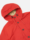 Close-up of the Orange British Wax Cotton Boston Parka on a white background. The parka features a hood with drawstrings and button closure.