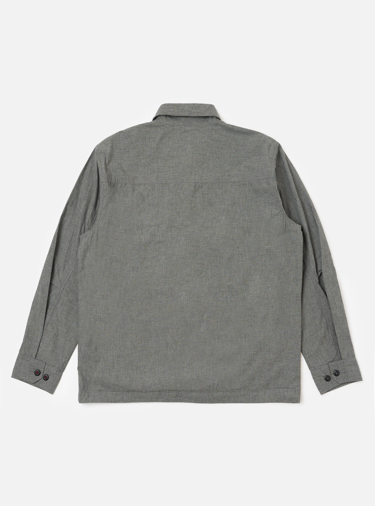 Back view of the Charcoal Organic Chambray Parachute Field Jacket on a white background. The jacket is charcoal gray and made of chambray fabric. It has long sleeves and a button-down front.