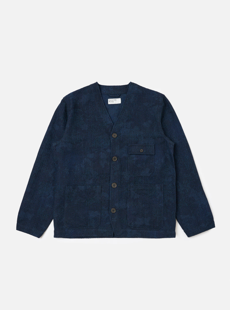 The Black/Indigo Denim Camo Cabin Jacket is displayed on a white background. The jacket has a button-up front, a pocket on the right breast, and long sleeves.