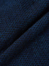 Close-up of the Black/Indigo Denim Camo Cabin Jacket fabric. The material is a textured blend of black and indigo threads, creating a subtle camo pattern.
