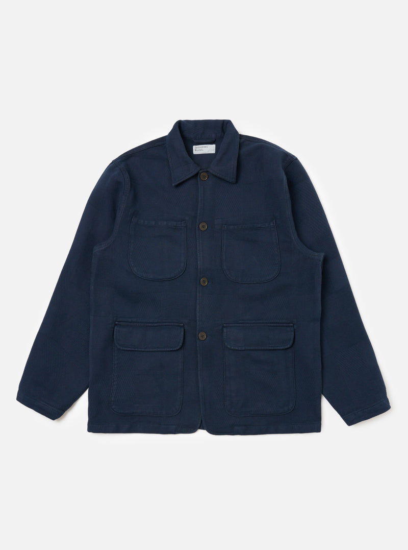 Dark Navy Patchwork Weave Cotton Labour Jacket on a white background. The jacket has four pockets and brown buttons.