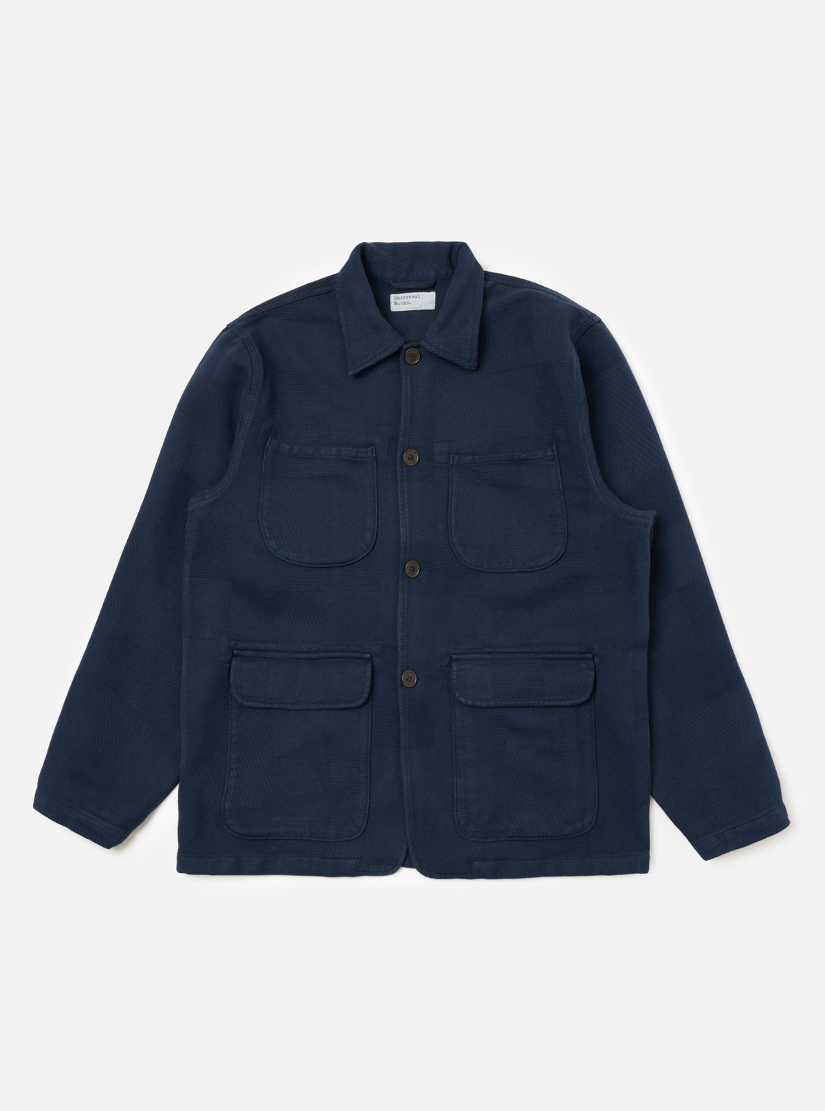 Dark Navy Patchwork Weave Cotton Labour Jacket on a white background. The jacket has four pockets and brown buttons.