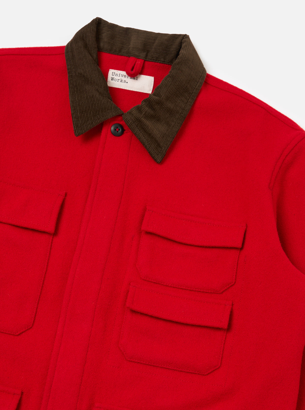 Close up of the Red Mowbray Military Fatigue Jacket on a white background. The jacket is red with a brown corduroy collar and multiple pockets.
