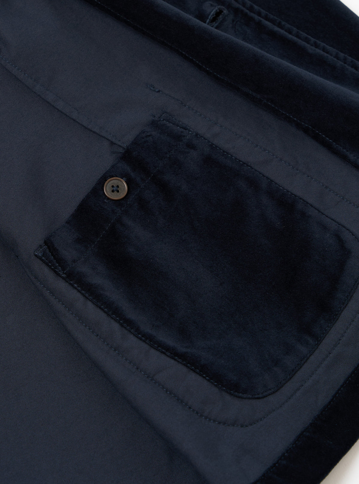 Close-up of the navy velveteen two button jacket, showing the soft texture and tailored fit. The jacket is displayed on a flat surface.