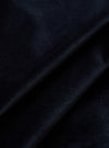 Close-up of the Navy Velveteen Two Button Jacket fabric. The rich, dark navy velveteen is draped to show texture. Studio shot on a neutral background.