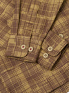 Close-up of the Khaki Patch Check Twill Fatigue Shirt. The shirt features a brown and khaki check pattern, twill fabric, and buttoned cuffs. The background is a plain white surface.