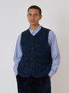 A man models the Black/Indigo Denim Camo 4 Pocket Gilet against a white backdrop. The gilet is indigo denim with a subtle camo pattern and four pockets.