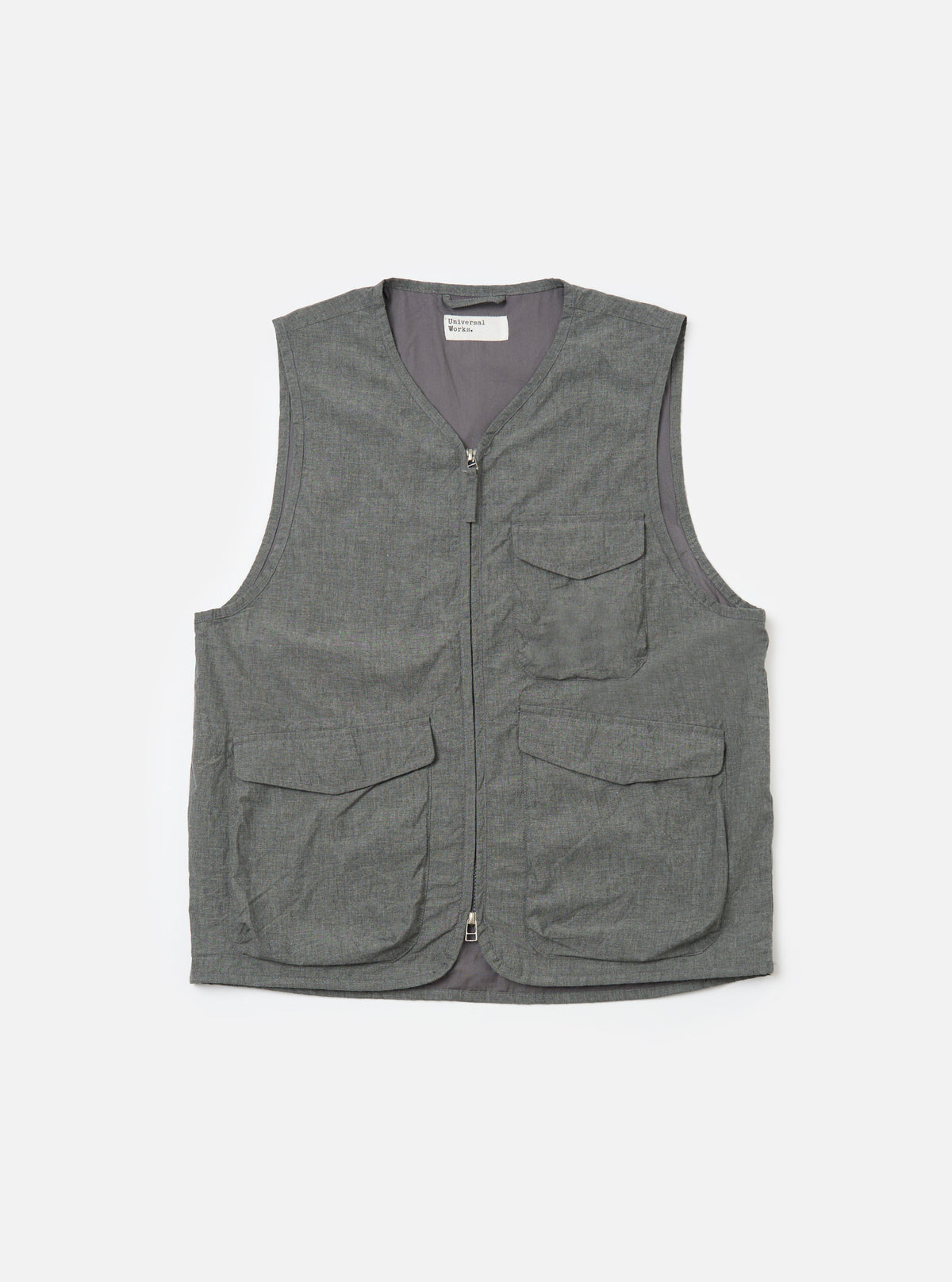 The Charcoal Organic Chambray Parachute Liner Gilet is displayed on a white background. The vest is charcoal gray and features a full zip front and four front pockets.