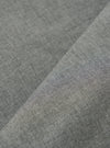 Close-up of the Charcoal Organic Chambray Parachute Liner Gilet fabric. The material is a woven chambray in a charcoal grey color. The fabric is folded to show texture.