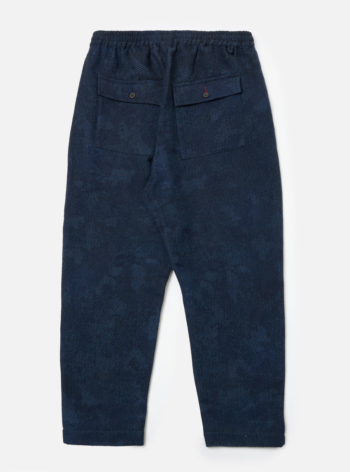 Back view of Black/Indigo Denim Camo Braga Pant on a white background. The pants have an elastic waist and two back pockets with button closures.