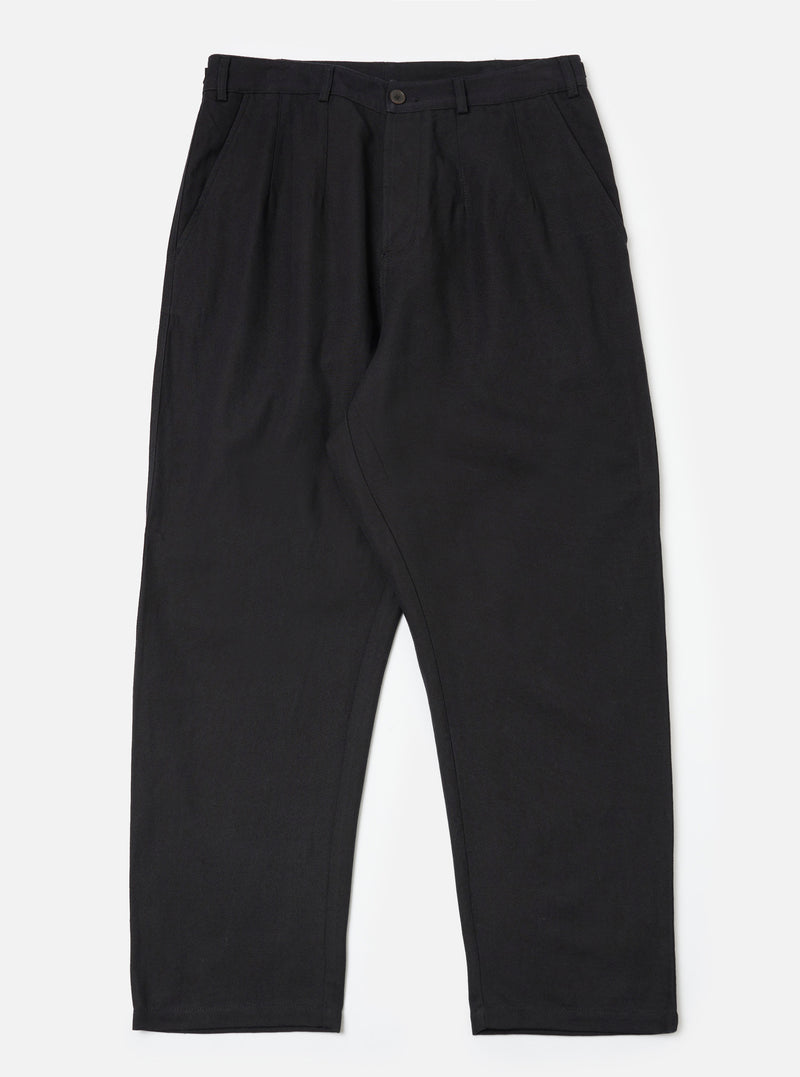 Flat lay of the Black Organic Canvas Dutch Pant on a white background. The pants are a relaxed fit and made of black canvas material.