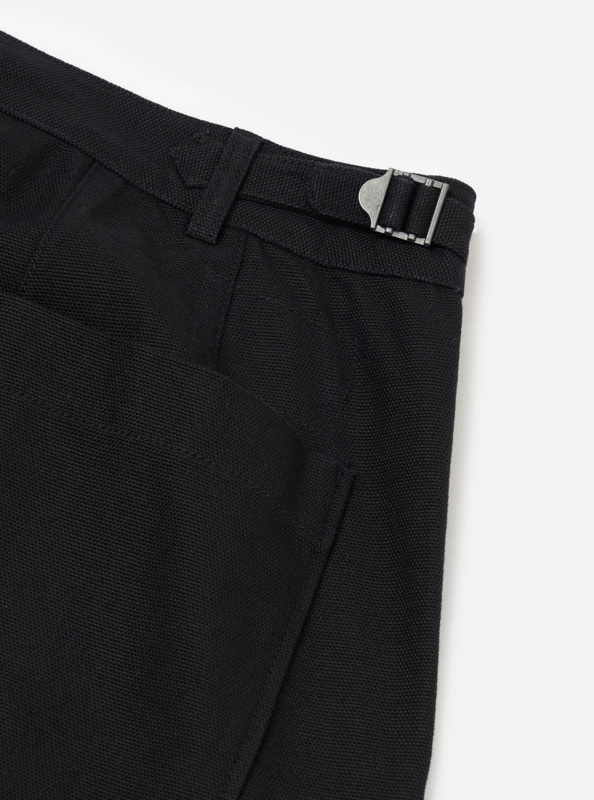 Close-up of the Black Organic Canvas Dutch Pant on a white background, showing the fabric texture and metal buckle detail.