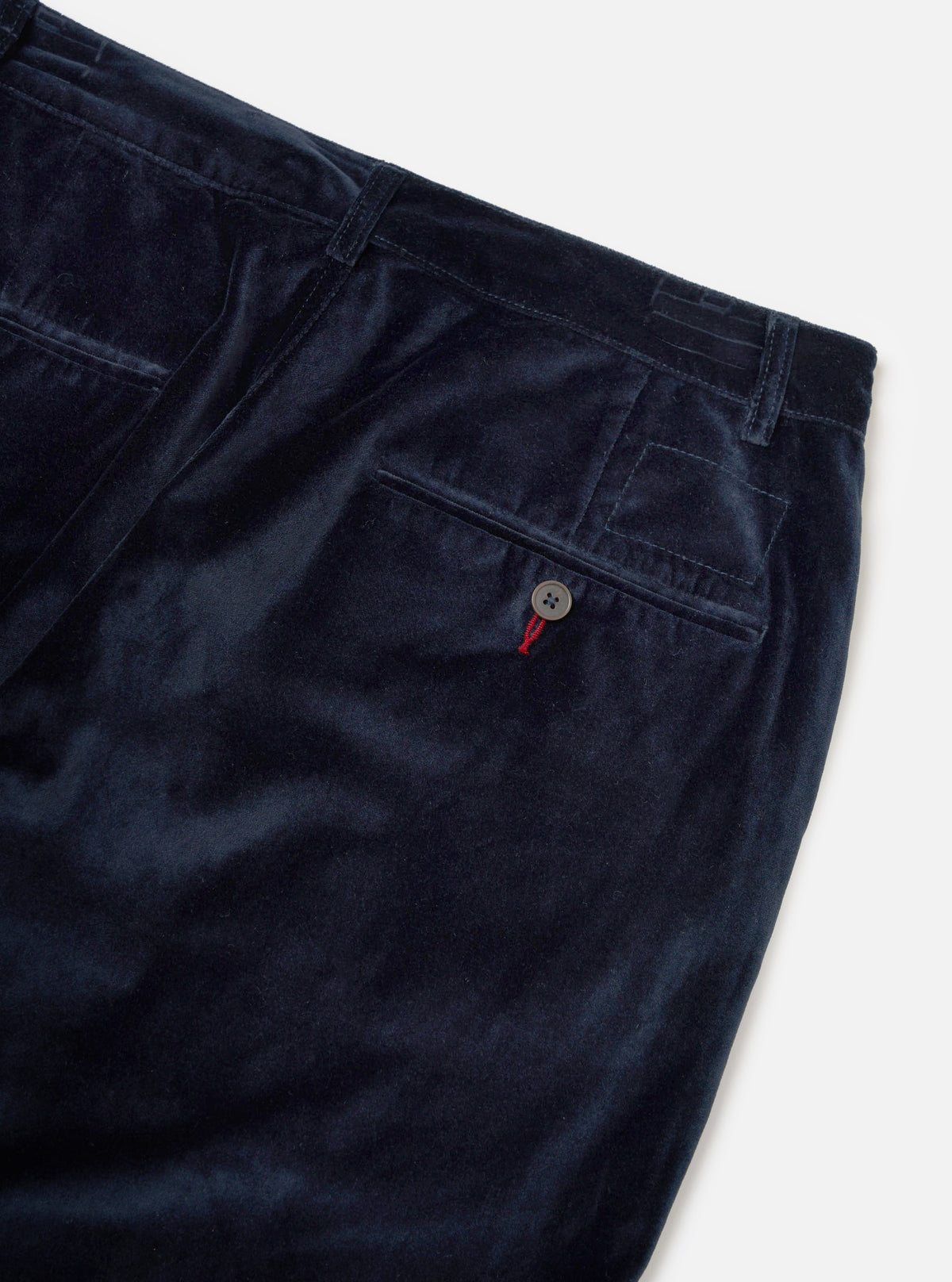Close-up of the Navy Velveteen Military Chino on a white background. The luxurious navy velvet material is visible, highlighting the chino's fit and style.
