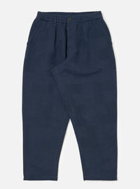 Dark navy patchwork weave cotton pleated track pant on a white background. The pants have a relaxed fit and a subtle textured pattern.